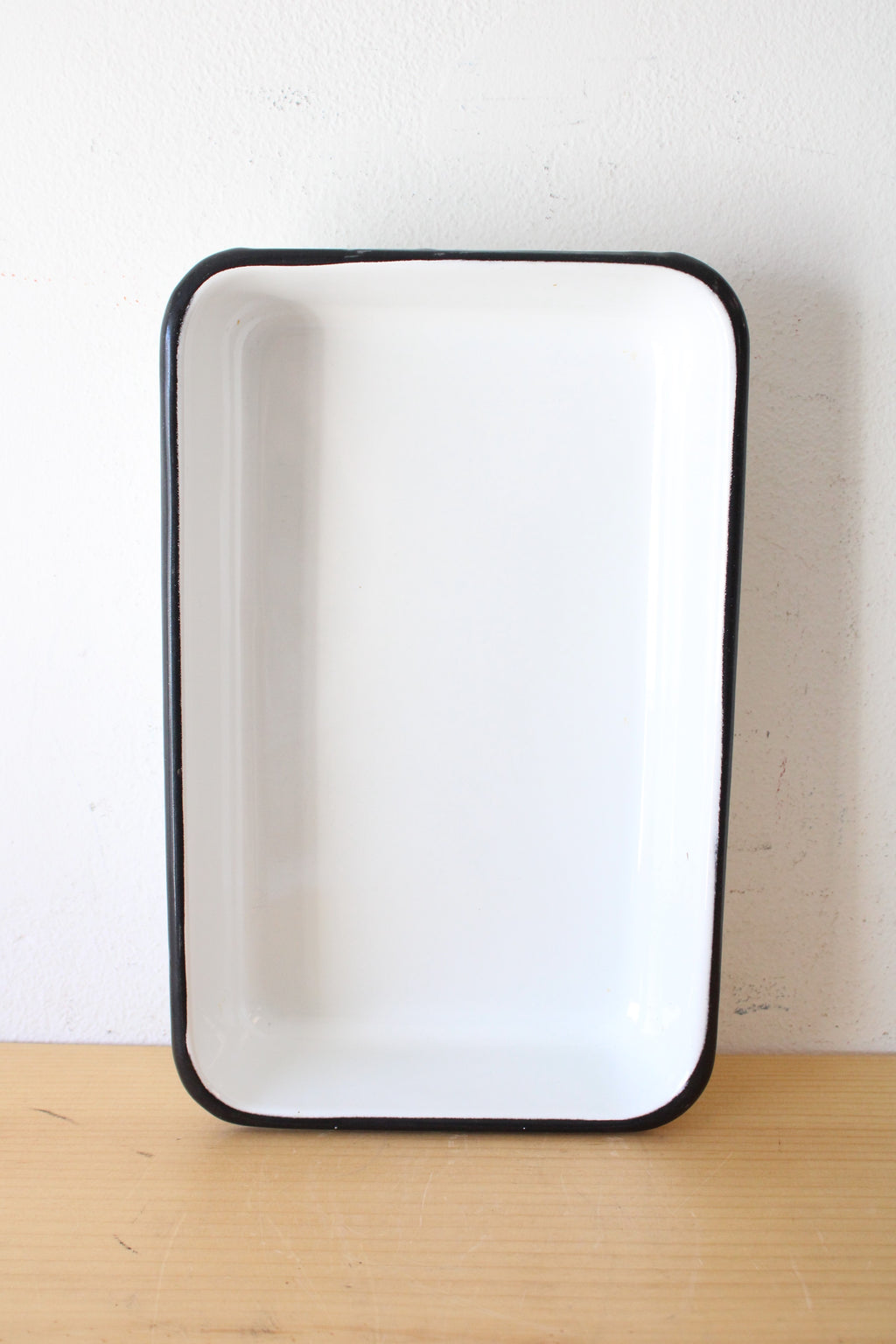 Black Rimmed White Enamelware Pan