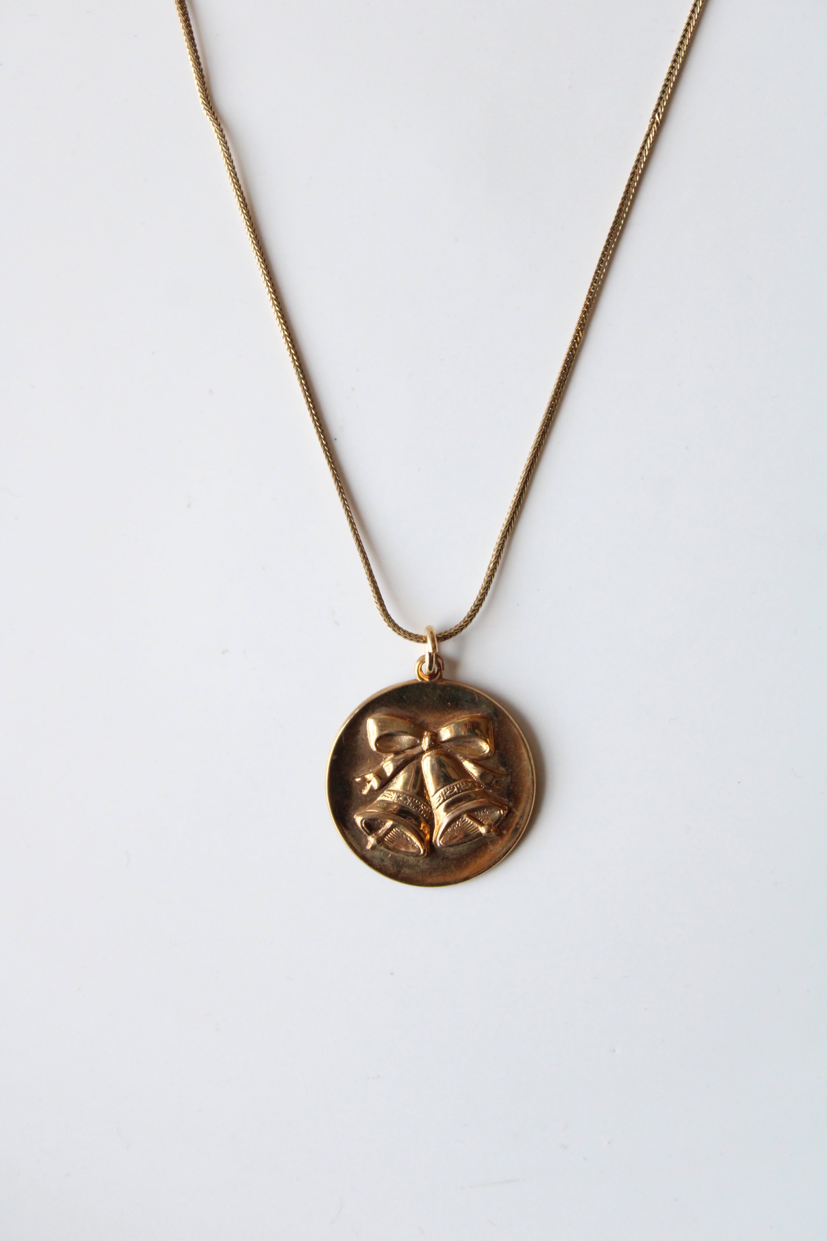 Bells & Bow Engraved Round Pendant Gold Necklace