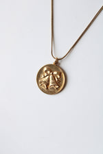 Bells & Bow Engraved Round Pendant Gold Necklace